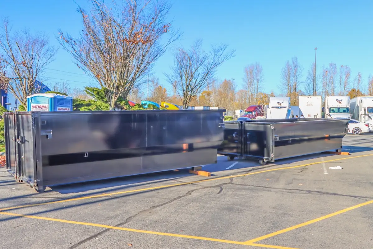 Professional dumpster rental service with roll-off container on residential driveway in Arvin